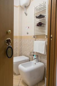 a bathroom with a white sink and a toilet at Campi Flegrei House in Naples