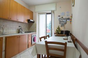 a kitchen with a table and chairs and a kitchen with a christmas tree at Campi Flegrei House in Naples