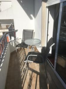 a balcony with two chairs and a table at HOTEL BOUTIQUE a ESPLANADA in Castelo Branco