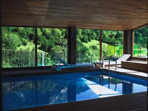 a house with a swimming pool with a view at Hotel Santa Cristina Petit Spa in Canfranc-Estación