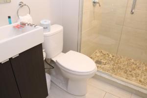 a bathroom with a toilet and a shower and a sink at A Stylish Stay w/ a Queen Bed, Heated Floors.. #14 in Brookline +15 photos