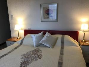 a bedroom with a large bed with two lamps at The Old Inn in Gairloch