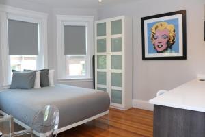 a bedroom with a bed and a painting on the wall at A Stylish Stay w/ a Queen Bed, Heated Floors.. #24 in Brookline