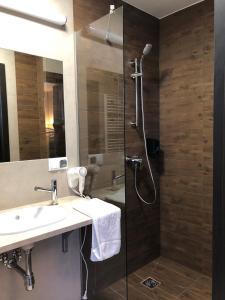 a bathroom with a shower, sink, and toilet at Hotel Sleep Wrocław in Wrocław