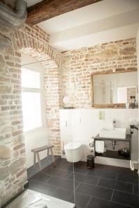a bathroom with a white toilet and a sink at Green Spirit Hotel in Regensburg
