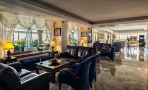 a living room with leather couches and chairs at Hotel Balcón de Europa in Nerja
