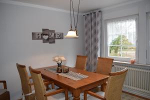 a dining room with a wooden table and chairs at Garbers-Hof in Undeloh