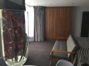 a living room with a glass vase and a couch at Carlton Hotel in Ilfracombe