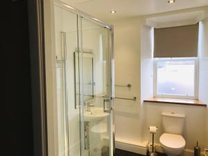 a bathroom with a shower, toilet, sink and tub at Crown and Anchor Inn in Findhorn