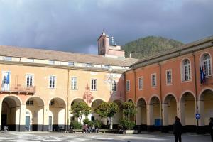 a group of buildings with people walking in a courtyard at Casa vacanza Francesca in Levanto