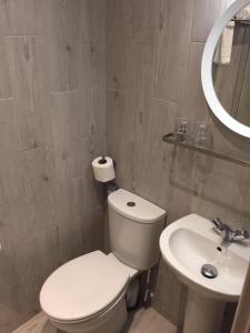 a bathroom with a white toilet and a sink at Carlton Hotel in Ilfracombe
