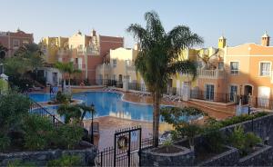 a resort with a swimming pool and some buildings at Apartments in Palm Mar in Palm-mar