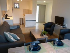 a living room with a couch and a table at Terrasses de Malmedy 453 in Malmedy