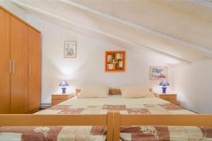 a bedroom with a bed and two night stands at Apartments Marija & Pepa in Rovinj
