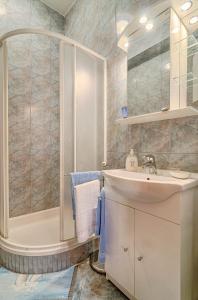 a bathroom with a tub and a sink and a shower at Apartments Marija & Pepa in Rovinj +26 photos