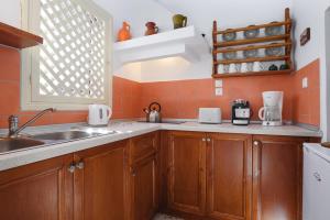 A kitchen or kitchenette at Thea Villas and Suite