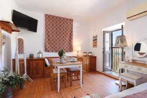 A television and/or entertainment centre at Thea Villas and Suite