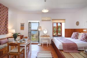 A bed or beds in a room at Thea Villas and Suite