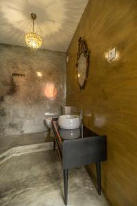 a bathroom with a toilet and a sink and a mirror at Memórias Charme Residences in Covilhã