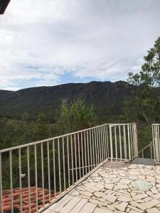 a balcony with a fence and a view of the mountains at Caminho das Lavras in Lavras Novas