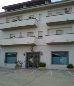 a large white building with a door and windows at Life Hotel in Ariano Irpino