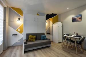 a living room with a couch and a table at Opal'évasion - RDC- Cocon pour 2 pers - 250m de la mer in Berck-sur-Mer