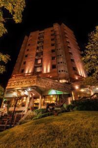 a tall building with lights on it at night at Hotel de la Cañada in Córdoba