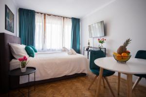 um quarto com uma cama e uma mesa com cadeiras em Studio Apartment Zen City Centre em Split