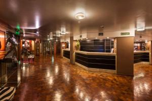 a lobby of a building with a tile floor at Hotel de la Cañada in Córdoba