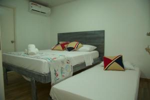 Postel nebo postele na pokoji v ubytování Hotel Nauticus