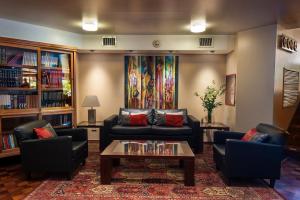 a living room with couches and a coffee table at Hotel de la Cañada in Córdoba