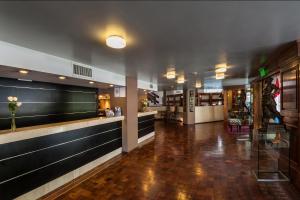 a lobby of a restaurant with a bar at Hotel de la Cañada in Córdoba