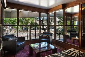 a living room with a lot of windows at Hotel de la Cañada in Córdoba