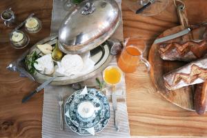 a table with bread and toast and a plate of food at Le Chateau de Claids in Saint-Patrice-de-Claids +24 photos