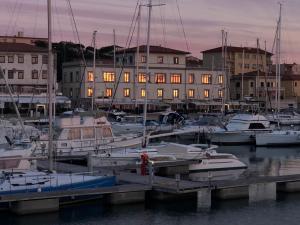 a group of boats docked in a marina with buildings at Liana monolocale in San Vincenzo