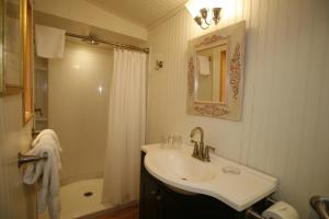 a bathroom with a sink and a shower and a tub at Country Cottage of Langley in Langley