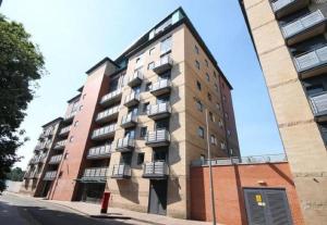 an apartment building on the corner of a street at Empire Serviced Apartments in Leicester