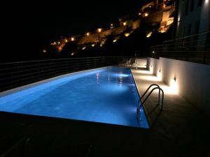 a large swimming pool at night on a building at Beira Rio in Mértola