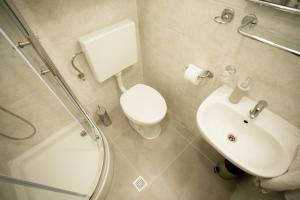 a bathroom with a toilet and a sink and a shower at Studio Apartment Zen City Centre in Split