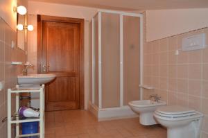a bathroom with a toilet and a sink and a shower at Casa Vacanze Roberta in Rivotorto