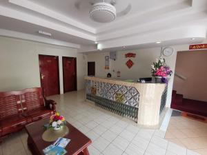 a living room with a couch and a counter at Indah Inn in Tawau