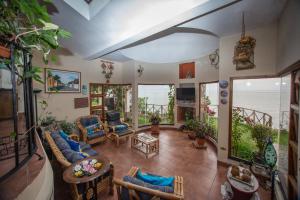 a living room with a view of the ocean at Santa María del Lago in San Pedro La Laguna