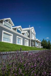 a large house with purple flowers in front of it at Los Ponchos Hotel in El Calafate