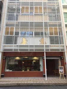 a facade of a building with a building with windows at Tang Guang Aeum Coffee Residence in Bangkok