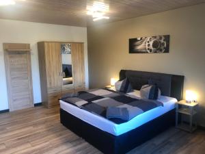 a bedroom with a large bed in a room at Pension Flying Ranch in Dermsdorf