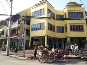 a horse drawn carriage parked in front of a building at Ban Mae Boonthong in Lampang +37 photos