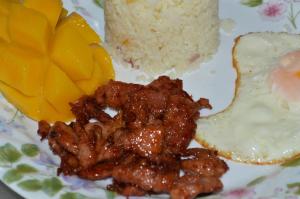 a plate of food with meat and rice on it at Bluewaves Westcliff Villa in Boracay