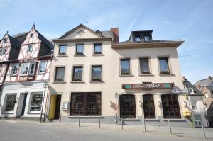 a white building on the corner of a street at Hotel Restaurant "Athen" in Münstermaifeld