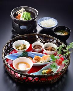 a basket of food with bowls of food on a table at Hakone Onsen Ryokan Yaeikan in Hakone +143 photos