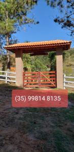 a sign in front of a pavilion with a fence at Sítio e Haras Alagoense in Alagoa